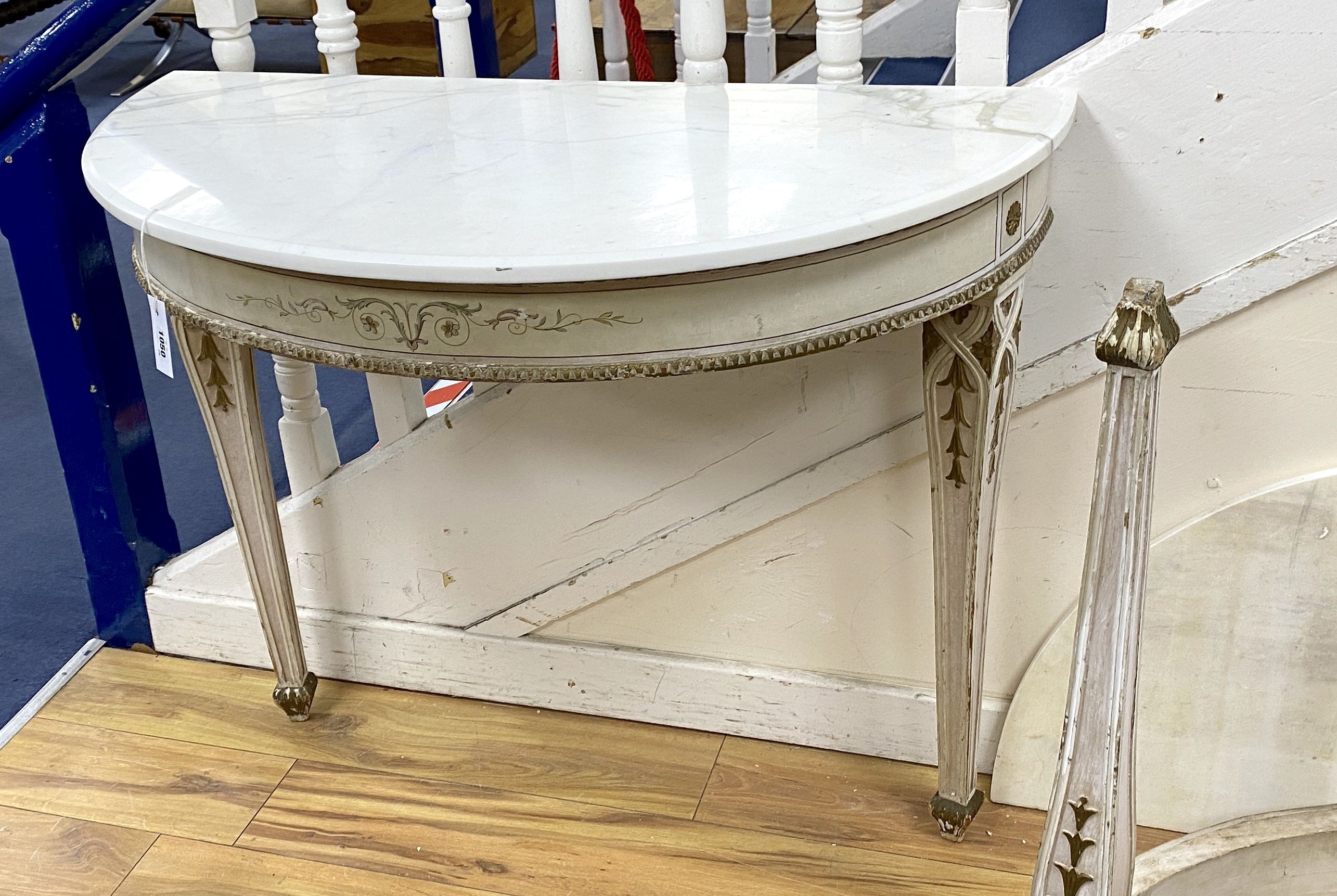A pair of French marble topped demi lune console tables, with later veined white marble tops and parcel gilt painted underframes, width 100cm depth 47cm height 79cm